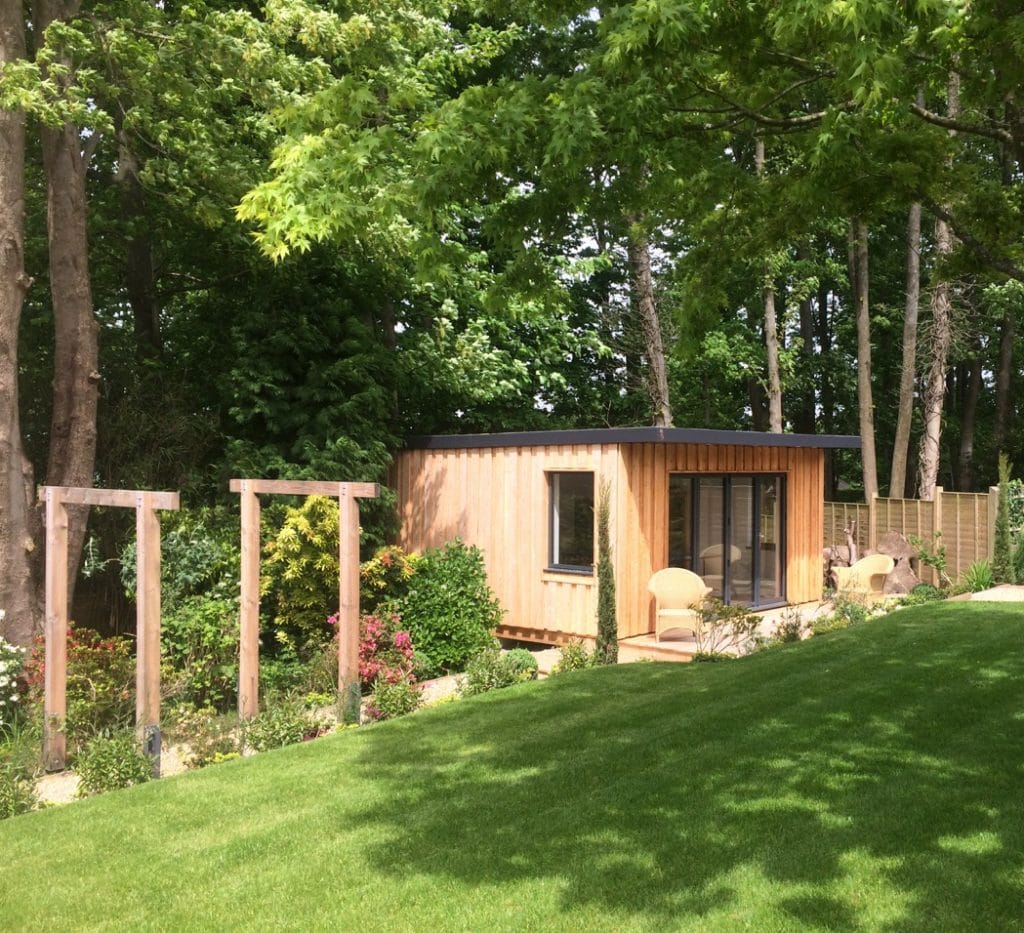 Timber clad garden room within woodland setting with custom designed pergola, Sussex