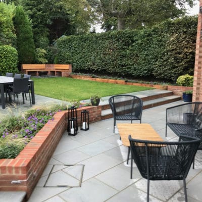 Patio with bespoke corner bench with fire pit, Kent and Sussex