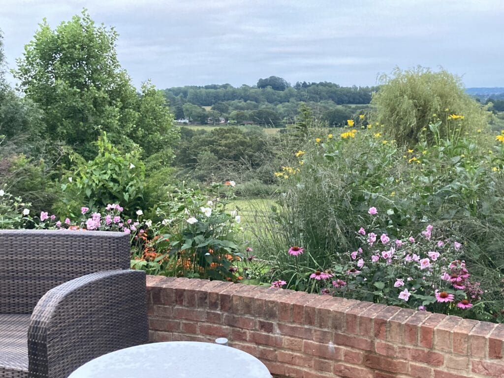 View from patio across countryside garden design Sussex Kent