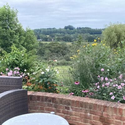 View from patio across countryside garden design Sussex Kent
