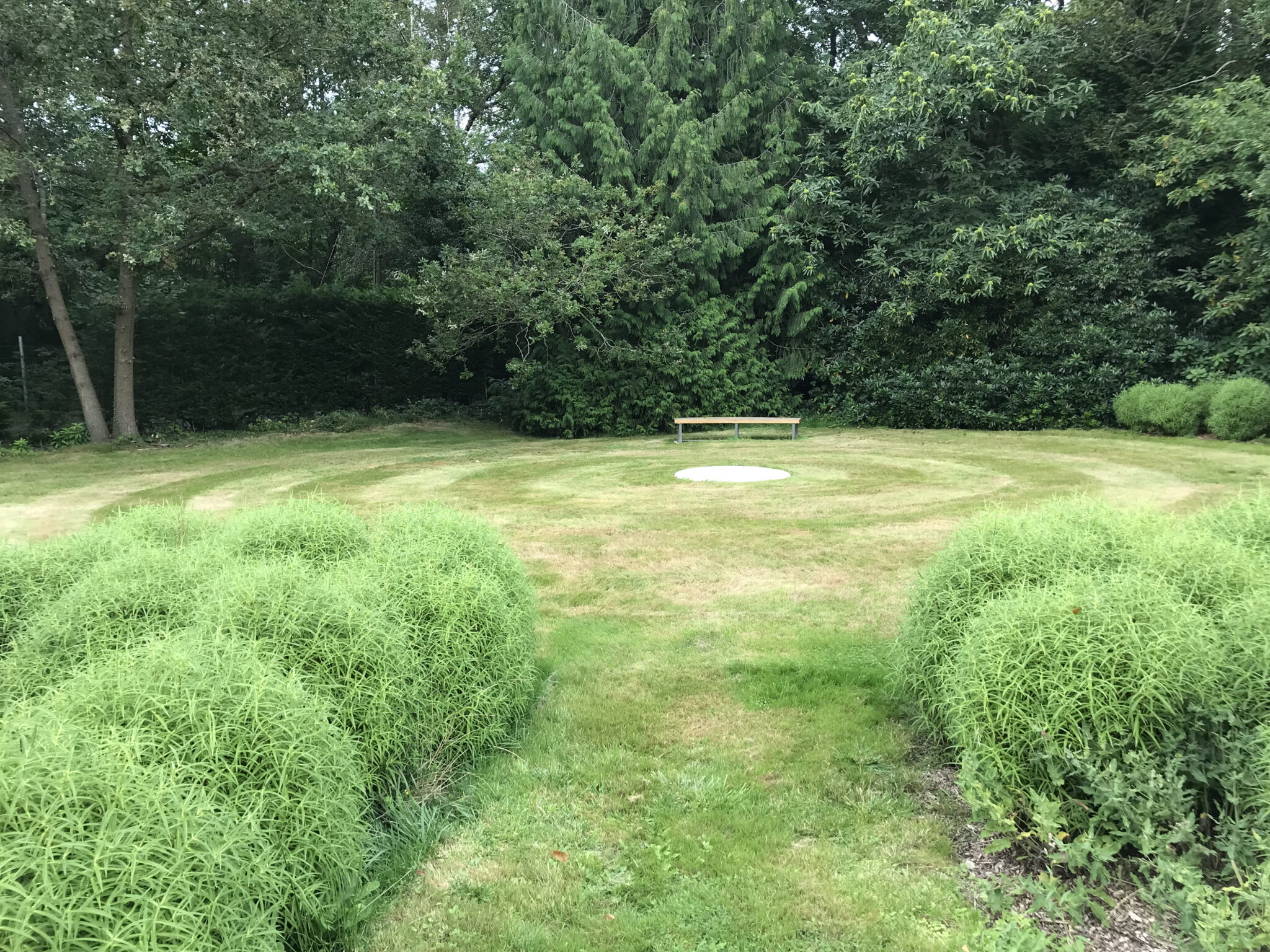 Plinth and curved steam bent bench garden design Sussex Kent